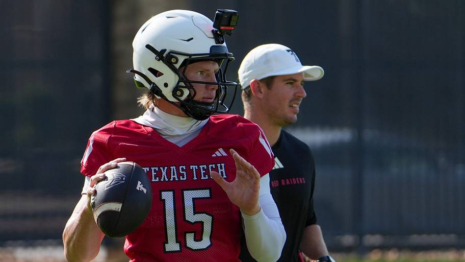 Texas Tech’s Will Hammond prepares to through as offensive coordinator Mack Leftwich looks on during football practice.