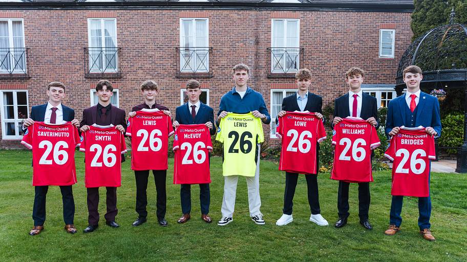 Wrexham's first-year scholars pose with commemorative shirts.
