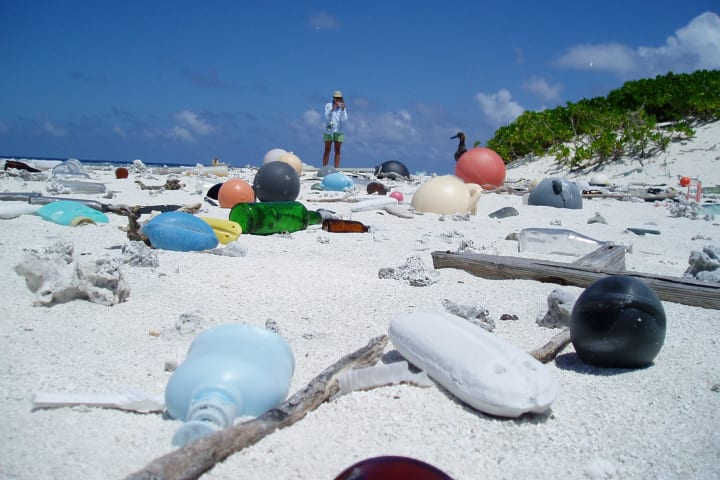 Plastic bottles and debris washed up on a tropical beach