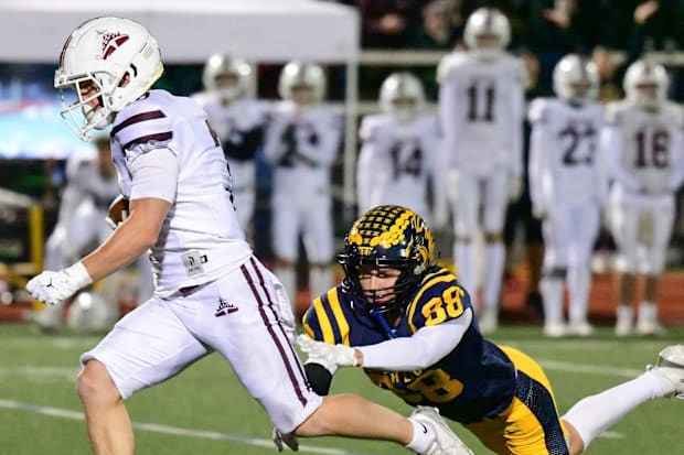 South Lyon's Brayden Knieper tackles Dexter's Cole Novara during the Division 2 football district final on Friday, Nov. 7, 20