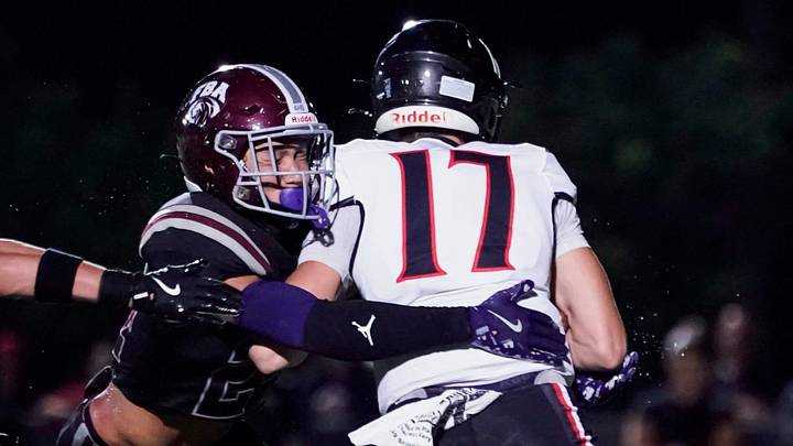First Baptist Academy Lions safety Logan Bartley (24) tackles Port Charlotte Pirates quarterback Logan Flaherty (17) in the backfield during the second quarter of a game at First Baptist Academy in Naples on Friday, Sept. 20, 2024.