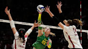 Wisconsin middle blocker Caroline Crawford (9) and opposite Anna Smrek (14) attempt to block the hit from Oregon outside hitter Mimi Colyer (15) during the fourth set of the NCAA Regional Volleyball Finals match on Saturday December 9, 2023 at the UW Field House in Madison, Wis.