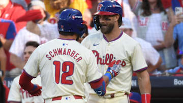 Philadelphia Phillies designated hitter Kyle Schwarber (12) celebrates with Philadelphia Phillies first baseman Bryce Harper (3) after a solo home run against the New York Mets in the first inning in game one of the NLDS for the 2024 MLB Playoffs at Citizens Bank Park.