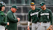 Michigan State's head coach Jake Boss Jr., center, talks to the team during a pitching change in the second inning on Wednesday, April 3, 2024, during the Crosstown Showdown against the Lugnuts at Jackson Field in Lansing.