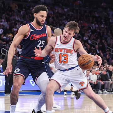 Mar 26, 2025; New York, New York, USA;  New York Knicks guard Tyler Kolek (13) looks to drive past LA Clippers guard Ben Simmons (25) in the third quarter at Madison Square Garden. Mandatory Credit: Wendell Cruz-Imagn Images