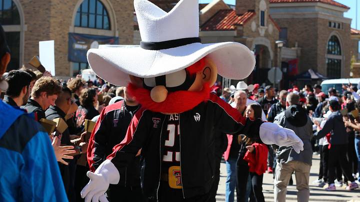 Nov 9, 2024; Lubbock, Texas, USA; The Texas Tech Red Raiders mascot greets fans before the the game between the Texas Tech Red Raiders and the Colorado Buffalos at Jones AT&T Stadium and Cody Campbell Field. Mandatory Credit: Michael C. Johnson-Imagn Images
