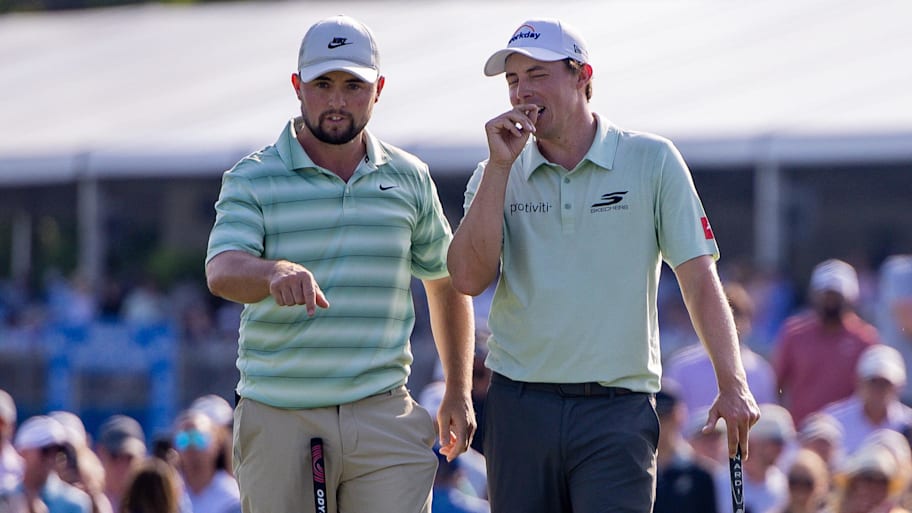 Alex Fitzpatrick talks with Matt after a shot from a sand trap on hole 18 during the final round of the Zurich Classic 