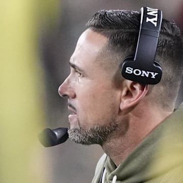 Green Bay Packers coach Matt LaFleur is viewed through the players on the sideline on Monday night. 
