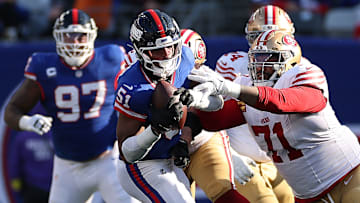 San Francisco 49ers left tackle Trent Williams (71) tries grabbing New York Giants linebacker Abdul Carter (51)