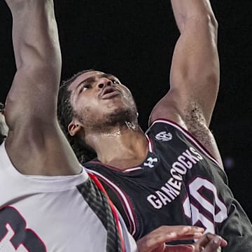 Jan 28, 2025; Athens, Georgia, USA; South Carolina Gamecocks forward Collin Murray-Boyles (30) dunks over Georgia Bulldogs forward Dylan James (13) during the second half at Stegeman Coliseum. Mandatory Credit: Dale Zanine-Imagn Images