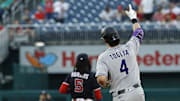 Jun 17, 2025; Washington, District of Columbia, USA; Colorado Rockies first baseman Michael Toglia (4) gestures to his bullpen while rounding the bases after hitting a two run home run against the Washington Nationals during the fourth inning at Nationals Park. Mandatory Credit: Geoff Burke-Imagn Images