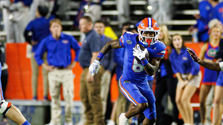Nov 29, 2025; Gainesville, Florida, USA; Florida Gators wide receiver Vernell Brown III (8) runs with the ball against the Florida State Seminoles during the first half at Ben Hill Griffin Stadium. Mandatory Credit: Matt Pendleton-Imagn Images