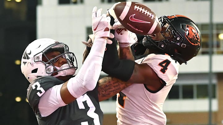 Oregon State Beavers defensive back Jaden Robinson, 4, breaks up a pass intended for Washington State Cougars wide receiver Josh Kelly in the second half at Gesa Field at Martin Stadium. 