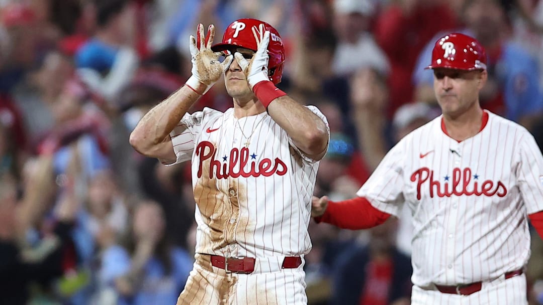 Oct 4, 2025; Philadelphia, Pennsylvania, USA; Philadelphia Phillies catcher J.T. Realmuto (10) reacts after hitting a two RBI triple against the Los Angeles Dodgers in the second inning during game one of the NLDS round for the 2025 MLB playoffs at Citizens Bank Park. Oct 4, 2025; Philadelphia, Pennsylvania, USA; Philadelphia Phillies catcher J.T. Realmuto (10) reacts after hitting a two RBI triple against the Los Angeles Dodgers in the second inning during game one of the NLDS round for the 2025 MLB playoffs at Citizens Bank Park.