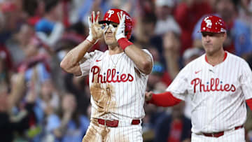 Oct 4, 2025; Philadelphia, Pennsylvania, USA; Philadelphia Phillies catcher J.T. Realmuto (10) reacts after hitting a two RBI triple against the Los Angeles Dodgers in the second inning during game one of the NLDS round for the 2025 MLB playoffs at Citizens Bank Park. 