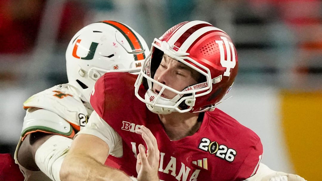 Miami (FL) Hurricanes defensive lineman Rueben Bain Jr. (4) wraps up Indiana Hoosiers quarterback Fernando Mendoza (15) on Monday, Jan. 19, 2026, during the College Football Playoff National Championship college football game at Hard Rock Stadium in Miami Gardens. Miami (FL) Hurricanes defensive lineman Rueben Bain Jr. (4) wraps up Indiana Hoosiers quarterback Fernando Mendoza (15) on Monday, Jan. 19, 2026, during the College Football Playoff National Championship college football game at Hard Rock Stadium in Miami Gardens.