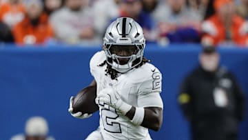 Nov 6, 2025; Denver, Colorado, USA; Las Vegas Raiders running back Ashton Jeanty (2) rushes the ball against the Denver Broncos during the first half at Empower Field at Mile High. Mandatory Credit: Isaiah J. Downing-Imagn Images