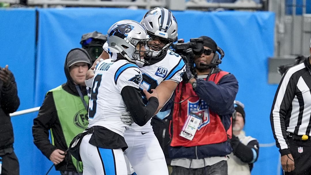 Dec 15, 2024; Charlotte, North Carolina, USA; Carolina Panthers quarterback Bryce Young (9) celebrates his touchdown with wide receiver David Moore (83) during the second half against the Dallas Cowboys at Bank of America Stadium. Mandatory Credit: Jim Dedmon-Imagn Images