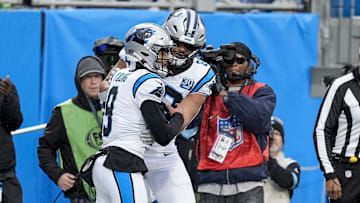 Dec 15, 2024; Charlotte, North Carolina, USA; Carolina Panthers quarterback Bryce Young (9) celebrates his touchdown with wide receiver David Moore (83) during the second half against the Dallas Cowboys at Bank of America Stadium. Mandatory Credit: Jim Dedmon-Imagn Images