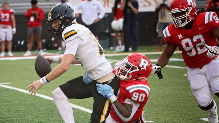A Neville Tiger tries to escape a Ruston defender