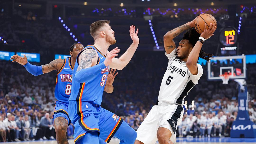 May 20, 2026; Oklahoma City, Oklahoma, USA; San Antonio Spurs guard Stephon Castle (5) looks to pass as Oklahoma City Thunder center Isaiah Hartenstein (55) defends during the first quarter during Game 2 of the Western Conference Finals for the 2026 NBA Playoffs at Paycom Center.