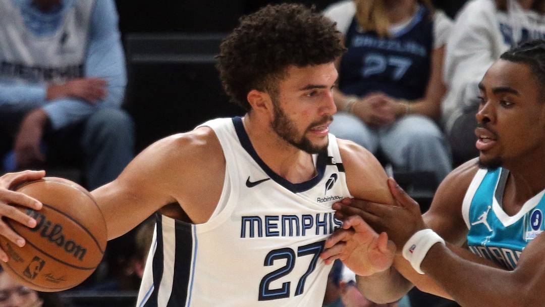 Oct 16, 2026; Memphis, Tennessee, USA;  Memphis Grizzlies forward Cameron Boozer (27) drives to the basket as Charlotte Hornets forward Micheal Ajayi (10) defends during the fourth quarter at FedExForum.  Mandatory Credit: Petre Thomas-Imagn Images