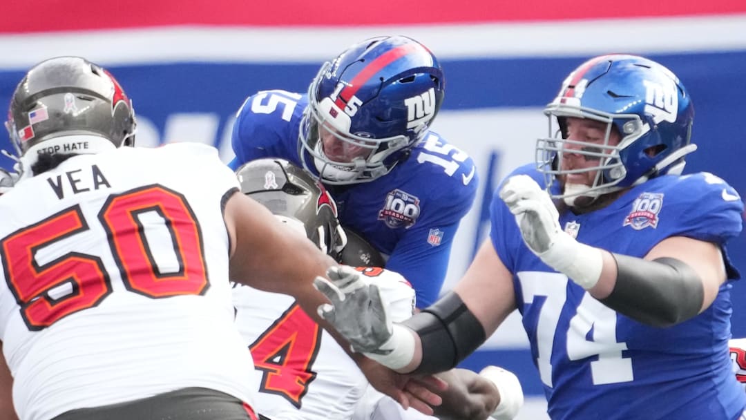 Nov 24, 2024; East Rutherford, New Jersey, USA; New York Giants quarterback Tommy DeVito (15) is stopped by the Tampa Bay Buccaneers defense during the first half at MetLife Stadium.  