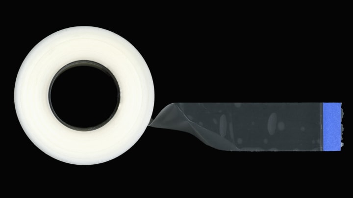 A roll of tape on a black background