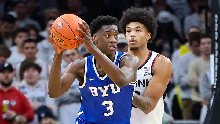 BYU's AJ Dybantsa, of Brockton, protects the ball from UConn's Jaylin Stewart during a game at TD Garden in Boston, Massachusetts on Saturday, Nov. 15, 2025.