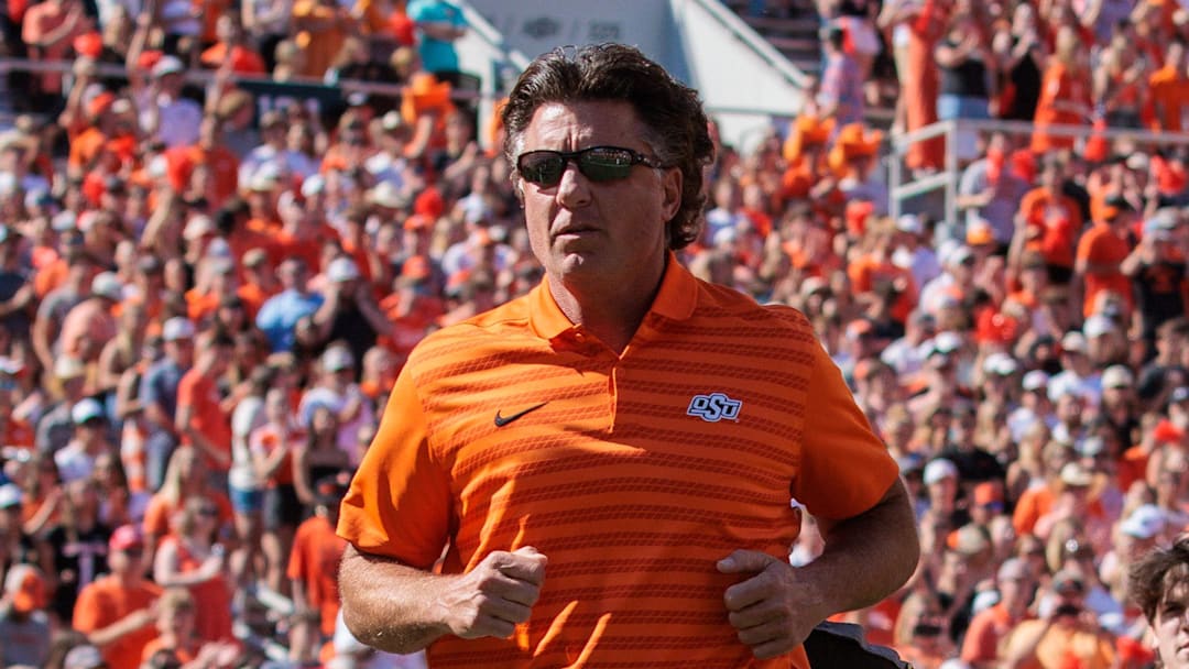 Oct 5, 2024; Stillwater, Oklahoma, USA; Oklahoma State Cowboys coach Mike Gundy enters the field for a game against the West Virginia Mountaineers at Boone Pickens Stadium. Mandatory Credit: William Purnell-Imagn Images