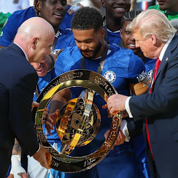 Gianni Infantino (left) and Donald Trump (right) both handed a replica Club World Cup trophy to Chelsea captain Reece James.