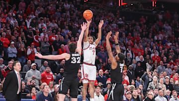 Jan 22, 2025; New York, New York, USA;  St. John's basketball guard Simeon Wilcher (7) takes a three point shot  past Xavier Musketeers forward Zach Freemantle (32) and  guard Ryan Conwell (7) in the second half at Madison Square Garden. 