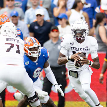 Sep 14, 2024; Gainesville, Florida, USA; Texas A&M Aggies quarterback Marcel Reed (10) scrambles with the ball past Florida Gators linebacker Shemar James (6) during the first half at Ben Hill Griffin Stadium. Mandatory Credit: Matt Pendleton-Imagn Images
