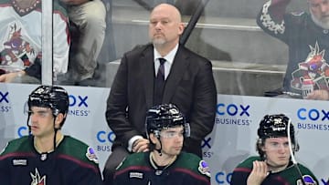 Mar 30, 2024; Tempe, Arizona, USA;  Arizona Coyotes head coach Andre Tourigny looks on prior to the game against the New York Rangers at Mullett Arena. Mandatory Credit: Matt Kartozian-Imagn Images