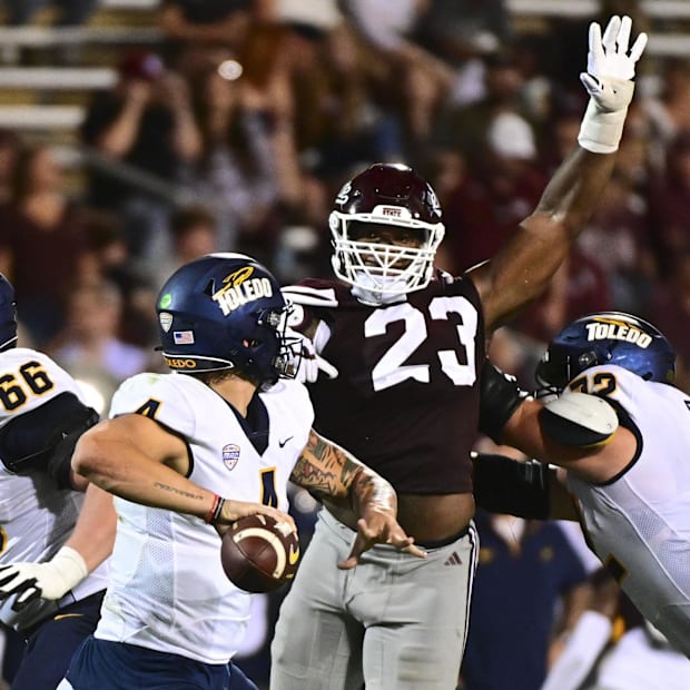 Mississippi State Bulldogs defensive lineman Trevion Williams (23) defends Toledo Rockets quarterback Tucker Gleason (4).