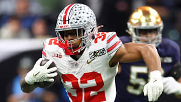 Jan 20, 2025; Atlanta, GA, USA; Ohio State Buckeyes running back TreVeyon Henderson (32) runs with the ball against the Notre Dame Fighting Irish during the first half the CFP National Championship college football game at Mercedes-Benz Stadium. Mandatory Credit: Mark J. Rebilas-Imagn Images