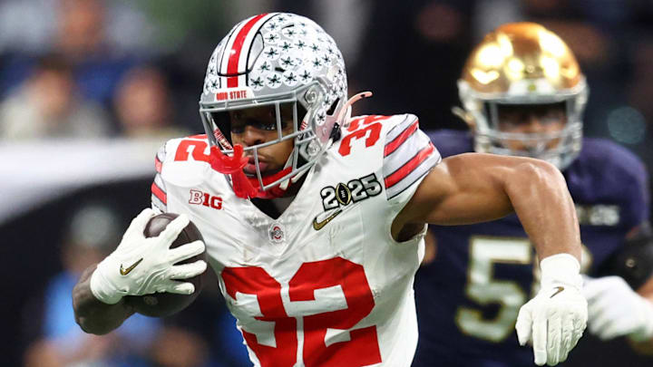 Jan 20, 2025; Atlanta, GA, USA; Ohio State Buckeyes running back TreVeyon Henderson (32) runs with the ball against the Notre Dame Fighting Irish during the first half the CFP National Championship college football game at Mercedes-Benz Stadium. Mandatory Credit: Mark J. Rebilas-Imagn Images