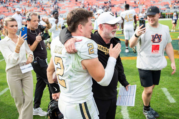 Diego Pavia and Jerry Kill embrace after a game.