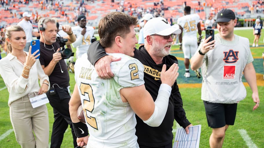 Diego Pavia and Jerry Kill embrace after a game.