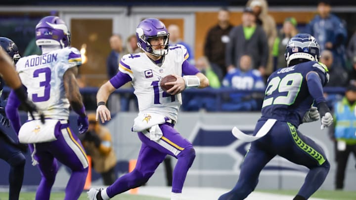 Dec 22, 2024; Seattle, Washington, USA; Minnesota Vikings quarterback Sam Darnold (14) rushes against the Seattle Seahawks during the fourth quarter at Lumen Field. Dec 22, 2024; Seattle, Washington, USA; Minnesota Vikings quarterback Sam Darnold (14) rushes against the Seattle Seahawks during the fourth quarter at Lumen Field.