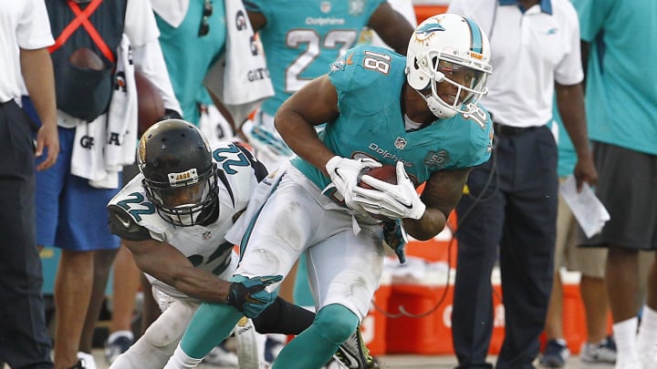 Sep 20, 2015; Jacksonville, FL, USA; Jacksonville Jaguars cornerback Aaron Colvin (22) tackles Miami Dolphins wide receiver Rishard Matthews (18) during the second half of an NFL Football game at EverBank Field. The Jacksonville Jaguars won 23-20.