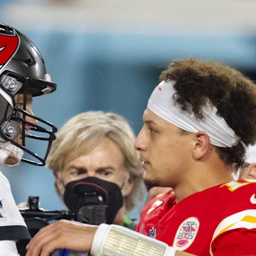 Tampa Bay Buccaneers quarterback Tom Brady greets Kansas City Chiefs quarterback Patrick Mahomes.