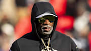Nov 23, 2024; Kansas City, Missouri, USA;  Colorado head coach Deion Sanders watches his players warmup prior to the game between the Kansas Jayhawks and the Colorado Buffaloes at GEHA Field at Arrowhead Stadium. Mandatory Credit: Nick Tre. Smith-Imagn Images