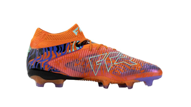 Orange and blue PUMA soccer cleats.