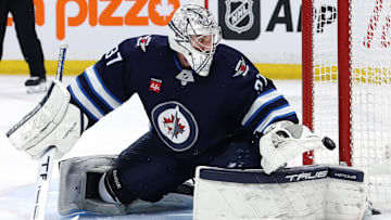 Jan 2, 2025; Winnipeg, Manitoba, CAN; Winnipeg Jets goaltender Connor Hellebuyck (37) watches the puck cross the goal line in the first period against the Anaheim Ducks at Canada Life Centre. Mandatory Credit: James Carey Lauder-Imagn Images