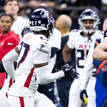 Jan 7, 2024; New Orleans, Louisiana, USA;  New Orleans Saints quarterback Taysom Hill (7) is chased out of bounds by Atlanta Falcons safety Richie Grant (27) during the second half at Caesars Superdome. Mandatory Credit: Stephen Lew-Imagn Images