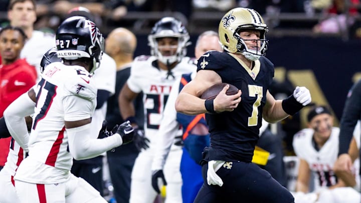 Jan 7, 2024; New Orleans, Louisiana, USA;  New Orleans Saints quarterback Taysom Hill (7) is chased out of bounds by Atlanta Falcons safety Richie Grant (27) during the second half at Caesars Superdome. Mandatory Credit: Stephen Lew-Imagn Images