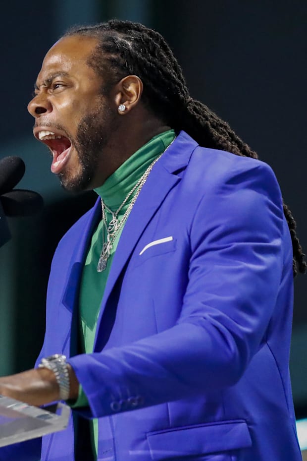 Former Seattle Seahawks cornerback Richard Sherman hypes up the crowd before announcing the team’s second round pick