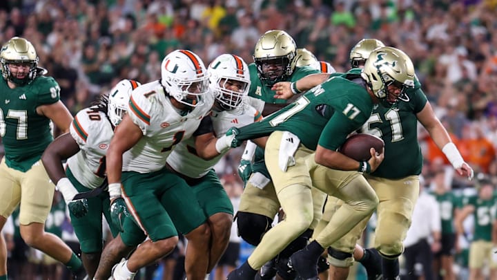 Sep 21, 2024; Tampa, Florida, USA; South Florida Bulls quarterback Byrum Brown (17) runs with the ball against the Miami Hurricanes in the first half  at Raymond James Stadium. Mandatory Credit: Nathan Ray Seebeck-Imagn Images