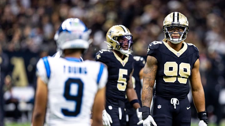 Sep 8, 2024; New Orleans, Louisiana, USA; Carolina Panthers defensive tackle Shy Tuttle (99) stares down Carolina Panthers quarterback Bryce Young (9) on a time out during the first half at Caesars Superdome.